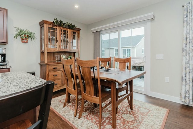 dining area with dark hardwood / wood-style floors