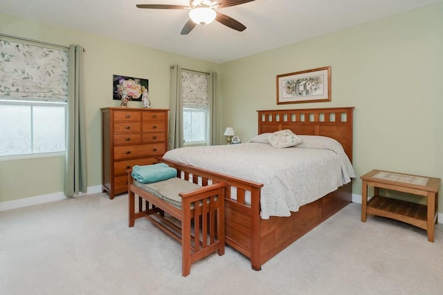 bedroom featuring light carpet and ceiling fan