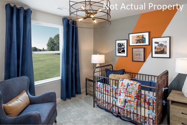 bedroom with baseboards, visible vents, an inviting chandelier, carpet flooring, and a nursery area