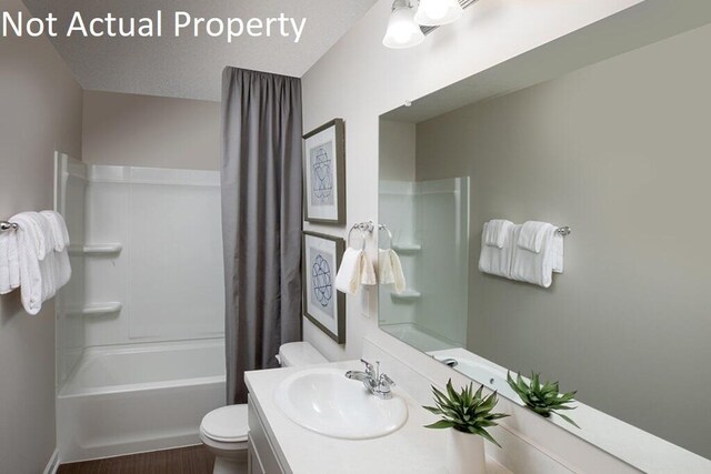 bathroom with vanity, toilet, and shower / bathtub combination