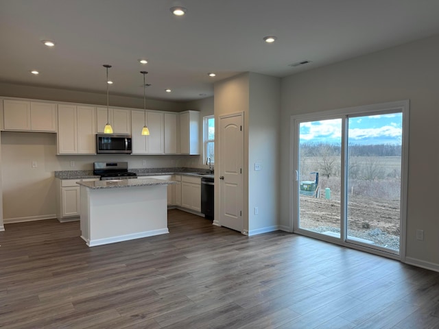 kitchen featuring white cabinetry, a center island, appliances with stainless steel finishes, and recessed lighting