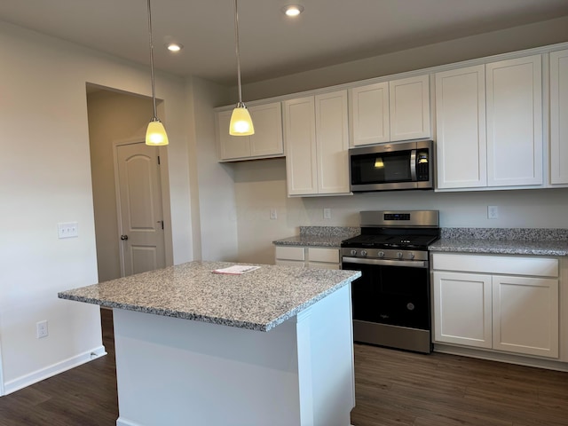 kitchen featuring white cabinetry, appliances with stainless steel finishes, dark wood-type flooring, and recessed lighting