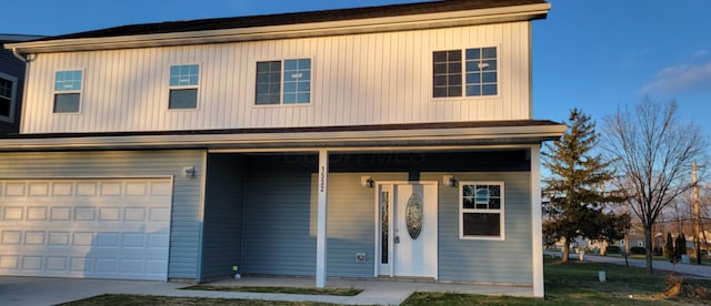 view of front of house with covered porch and a garage