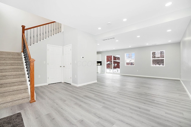 unfurnished living room with light hardwood / wood-style flooring