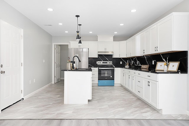 kitchen featuring a center island with sink, white cabinets, hanging light fixtures, and appliances with stainless steel finishes