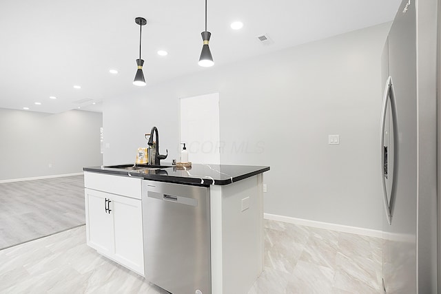 kitchen with pendant lighting, a center island, sink, appliances with stainless steel finishes, and white cabinetry