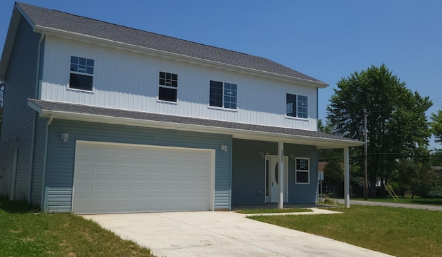 1532 Westmeadow Dr, Columbus, OH 43223 - view of front of house featuring an attached garage, covered porch, concrete driveway, and a front yard