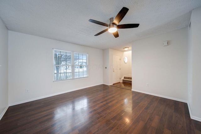 empty room featuring a textured ceiling, ceiling fan, and dark hardwood / wood-style flooring