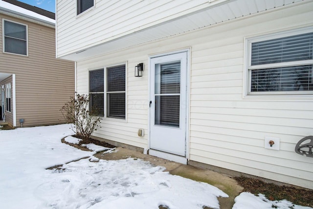 view of snow covered property entrance