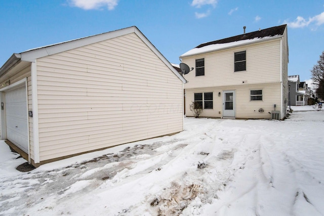 snow covered house with a garage