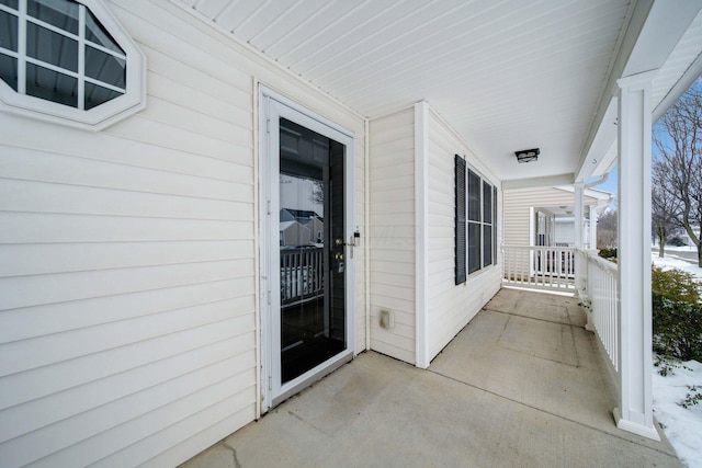 view of exterior entry featuring a porch