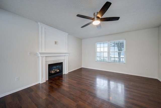 unfurnished living room with a fireplace, ceiling fan, a textured ceiling, and dark hardwood / wood-style floors