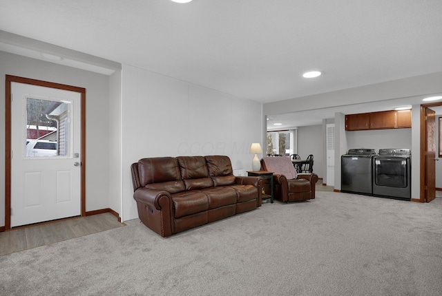 living room featuring light colored carpet and washer and dryer