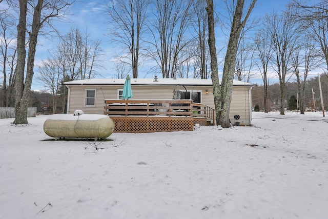 snow covered property featuring a wooden deck