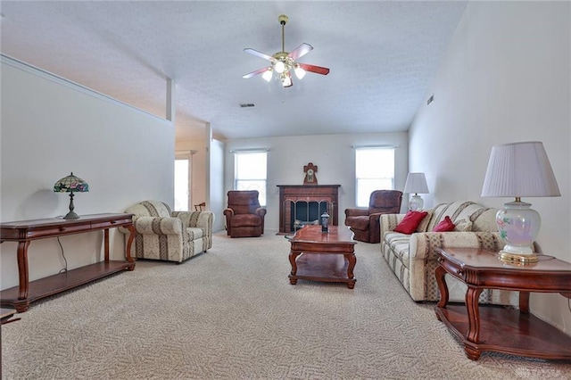 carpeted living room featuring a textured ceiling, ceiling fan, and lofted ceiling