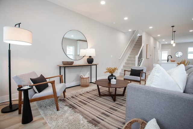 living room with sink and light hardwood / wood-style floors