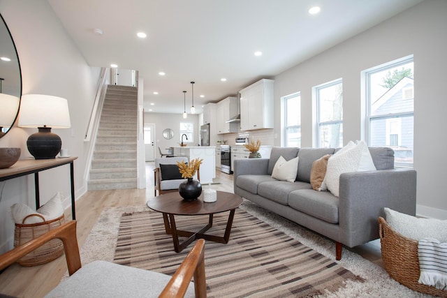 living room featuring light wood-type flooring and sink