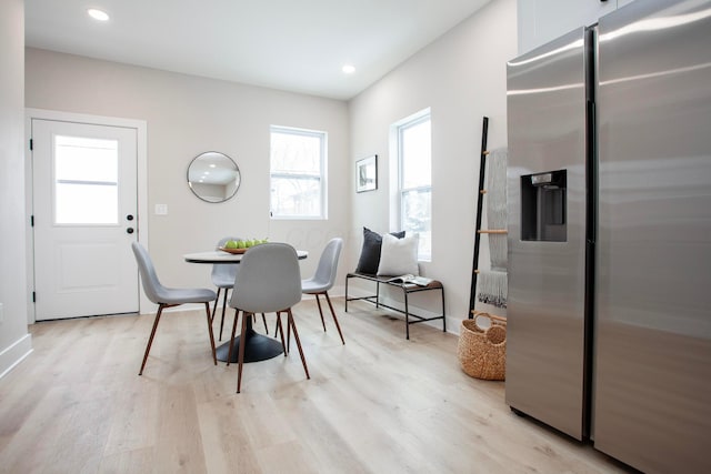 dining space featuring light wood-type flooring