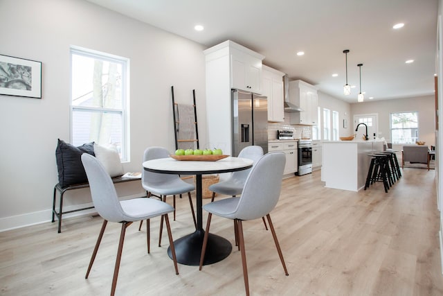 dining area featuring light wood-type flooring