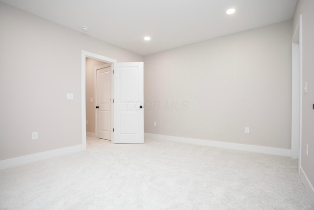 unfurnished room with light carpet