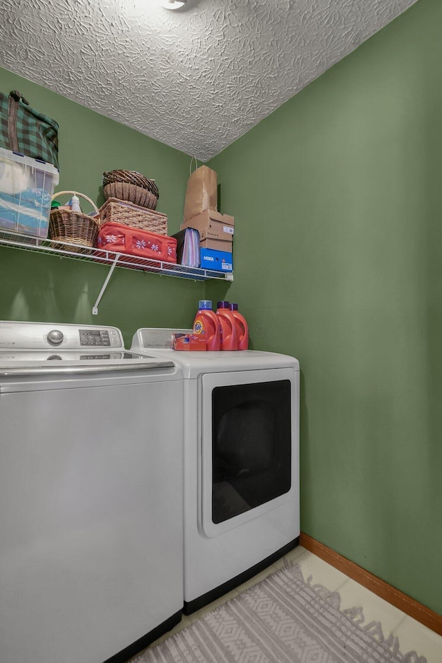 laundry area with washer and dryer and a textured ceiling