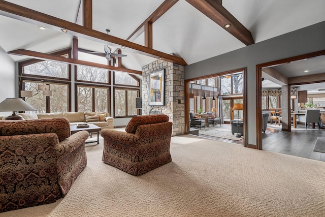 living area featuring high vaulted ceiling, beamed ceiling, and carpet