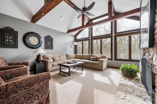 carpeted living room featuring ceiling fan, high vaulted ceiling, a fireplace, and beam ceiling