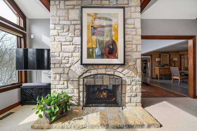 living room with visible vents, a fireplace, and baseboards