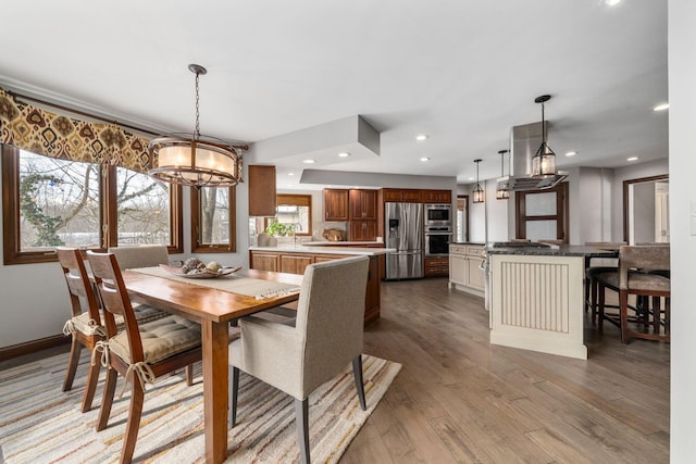 dining space featuring a chandelier, wood finished floors, and recessed lighting