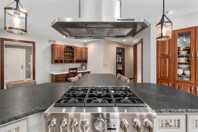 kitchen with island range hood, brown cabinetry, decorative backsplash, dark countertops, and open shelves