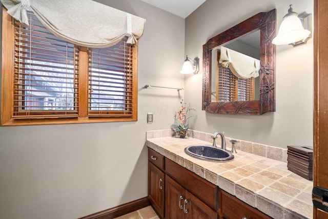 bathroom featuring baseboards and vanity