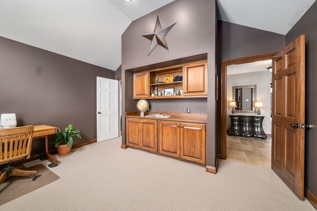 home office with light carpet, baseboards, and vaulted ceiling