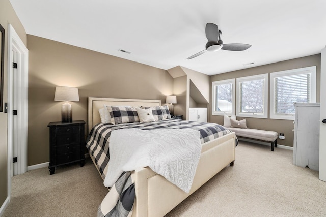 bedroom with light carpet, baseboards, and a ceiling fan