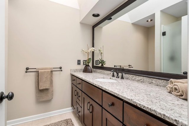 bathroom with tile patterned flooring, vanity, and baseboards