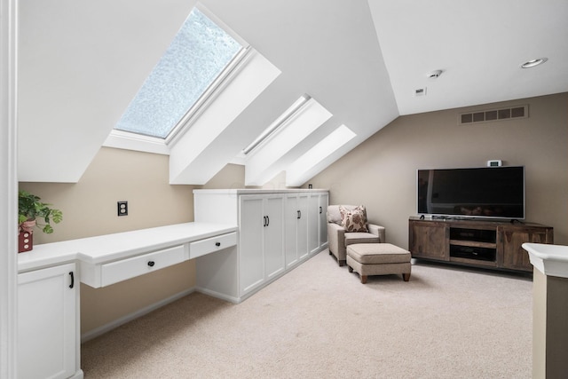 bonus room featuring light colored carpet, visible vents, and vaulted ceiling with skylight