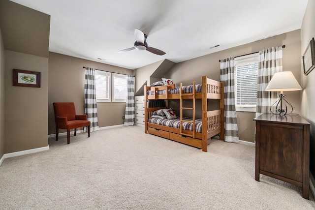 carpeted bedroom featuring visible vents, ceiling fan, and baseboards