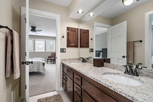 ensuite bathroom featuring a sink, double vanity, and connected bathroom