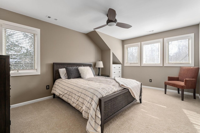 bedroom with baseboards, visible vents, and light colored carpet