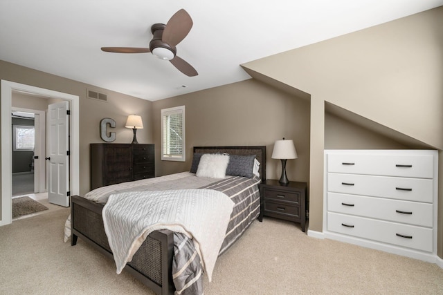 bedroom featuring light carpet, visible vents, and a ceiling fan