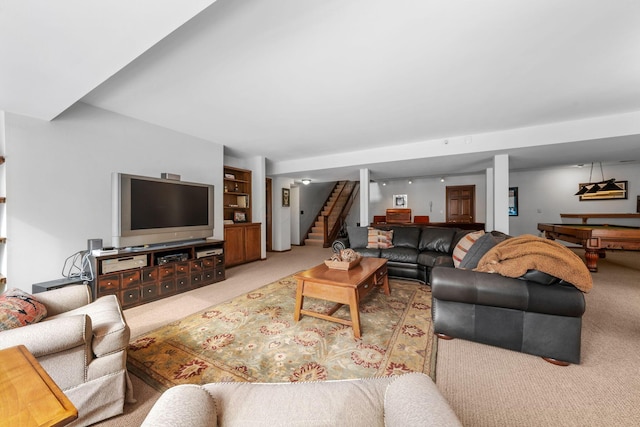 living room with stairway and light colored carpet