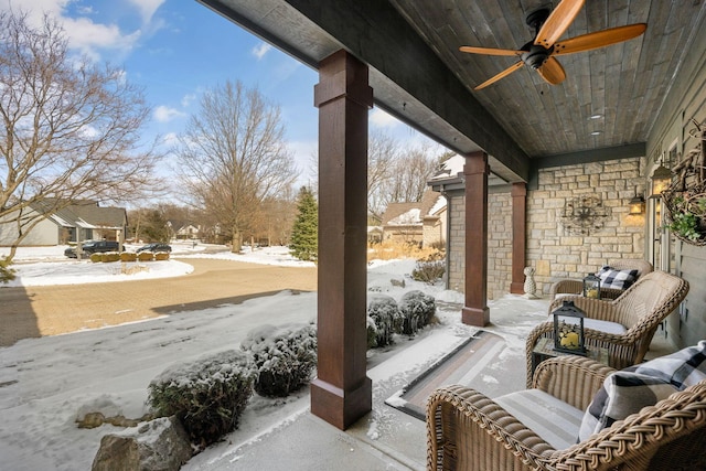 snow covered patio with a ceiling fan