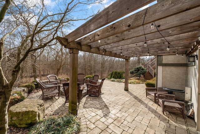 view of patio / terrace with stairway and a pergola