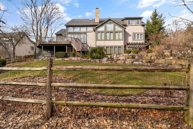 back of house with a chimney, stairway, fence, a deck, and stucco siding