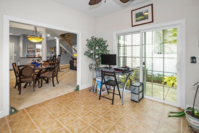 carpeted office space featuring ceiling fan