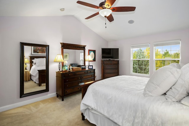 carpeted bedroom with vaulted ceiling and ceiling fan