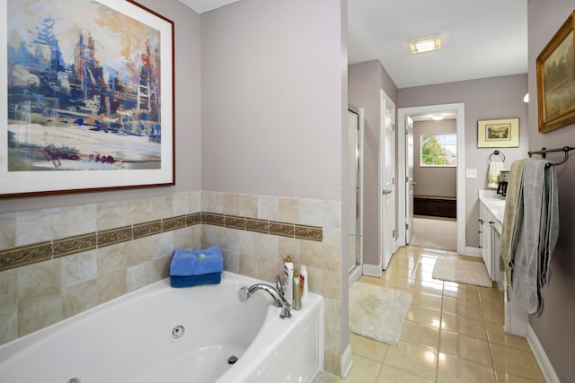 bathroom with vanity, tile patterned floors, and a tub