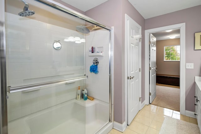 bathroom with tile patterned flooring and enclosed tub / shower combo