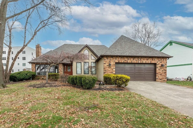 view of front of property with a garage and a front lawn