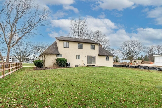 rear view of property featuring a yard