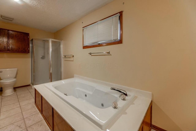 bathroom with tile patterned flooring, a textured ceiling, toilet, and separate shower and tub